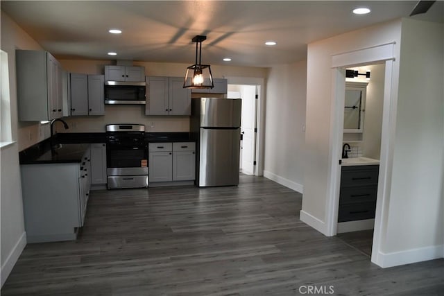 635 N Plumas St, Willows, CA 95988 - kitchen with stainless steel appliances, dark countertops, baseboards, a sink, and recessed lighting