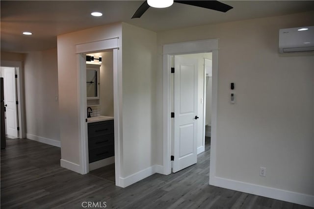 635 N Plumas St, Willows, CA 95988 - corridor with an AC wall unit, baseboards, dark wood finished floors, recessed lighting, and a sink