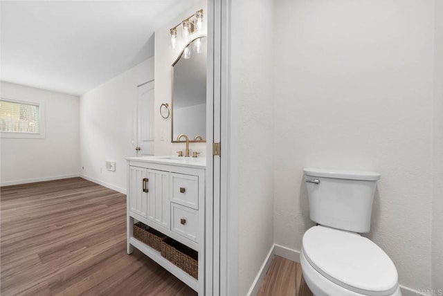 3825 Van Dyke Ave, San Diego, CA 92105 - bathroom with wood finished floors, baseboards, toilet, and vanity