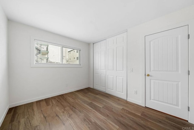 3825 Van Dyke Ave, San Diego, CA 92105 - unfurnished bedroom featuring wood finished floors, a closet, and baseboards
