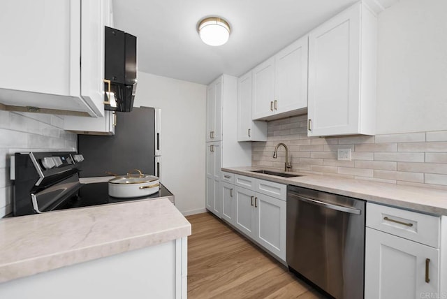 3825 Van Dyke Ave, San Diego, CA 92105 - kitchen featuring stainless steel appliances, a sink, light countertops, white cabinetry, and tasteful backsplash