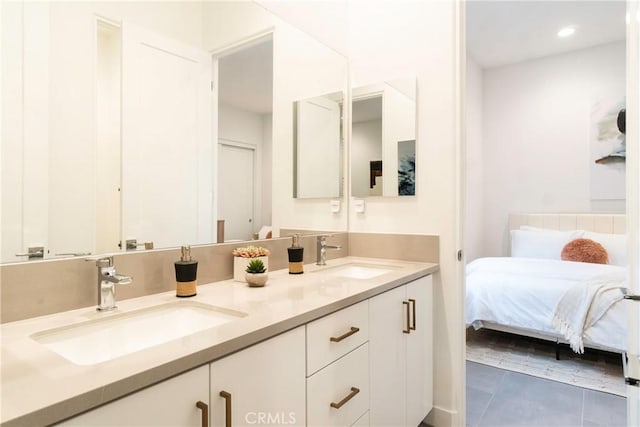 56231 Platinum Way, La Quinta, CA 92253 - bathroom featuring double vanity, tile patterned flooring, recessed lighting, and connected bathroom