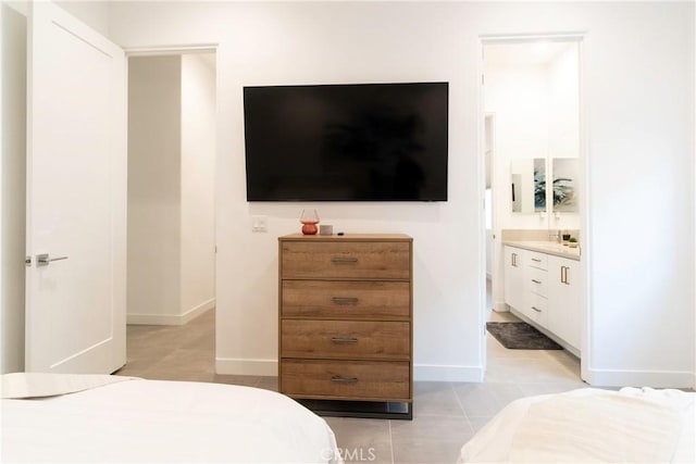 56231 Platinum Way, La Quinta, CA 92253 - bedroom featuring light tile patterned floors, ensuite bath, and baseboards