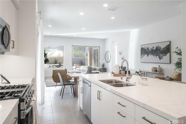56231 Platinum Way, La Quinta, CA 92253 - kitchen featuring a sink, open floor plan, appliances with stainless steel finishes, light stone countertops, and recessed lighting