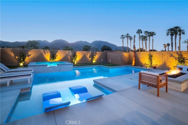 56231 Platinum Way, La Quinta, CA 92253 - view of swimming pool with a mountain view, an in-ground hot tub, a fire pit, and a fenced backyard