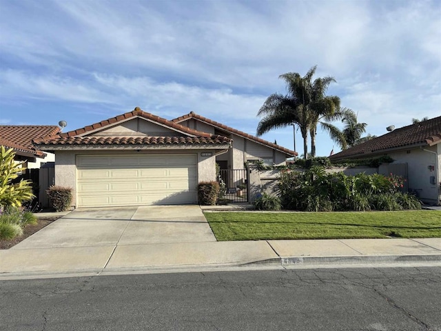 4843 Sumac Pl, Oceanside, CA 92057 - view of front of home with concrete driveway, an attached garage, stucco siding, a tiled roof, and a gate