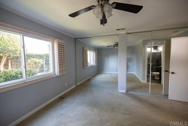 4843 Sumac Pl, Oceanside, CA 92057 - unfurnished bedroom with multiple closets, carpet, ornamental molding, baseboards, and a ceiling fan