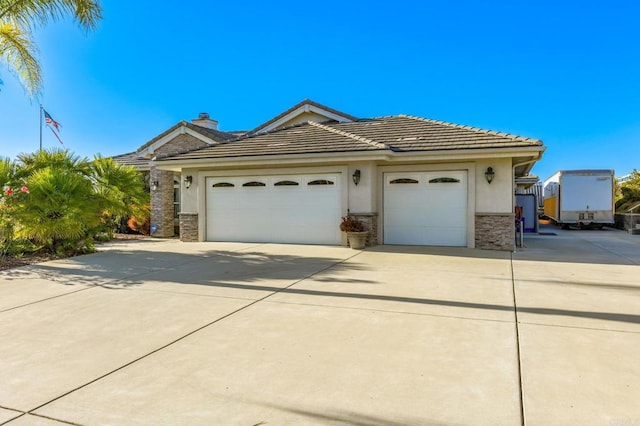 28623 Willow Park Rd, Escondido, CA 92026 - ranch-style house featuring stone siding, concrete driveway, an attached garage, stucco siding, and a tiled roof