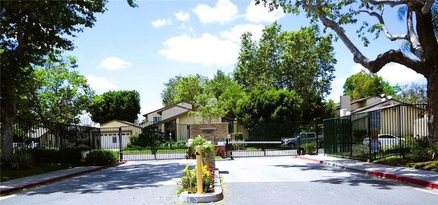 2622 N Tustin Ave Unit 147, Santa Ana, CA 92705 - view of asphalt road with a gate, curbs, and sidewalks
