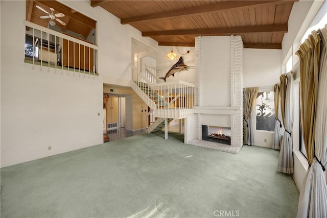 2622 N Tustin Ave Unit 147, Santa Ana, CA 92705 - unfurnished living room with carpet floors, wooden ceiling, high vaulted ceiling, stairs, and a fireplace