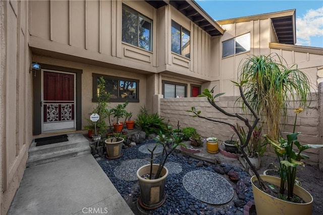 2622 N Tustin Ave Unit 147, Santa Ana, CA 92705 - view of exterior entry with board and batten siding, fence, stucco siding, and a patio area