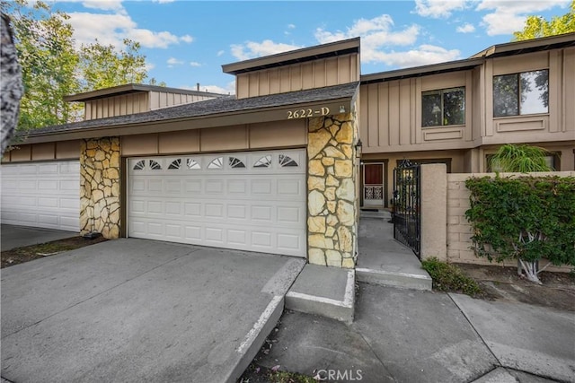 2622 N Tustin Ave Unit 147, Santa Ana, CA 92705 - townhome / multi-family property with board and batten siding, stone siding, and concrete driveway