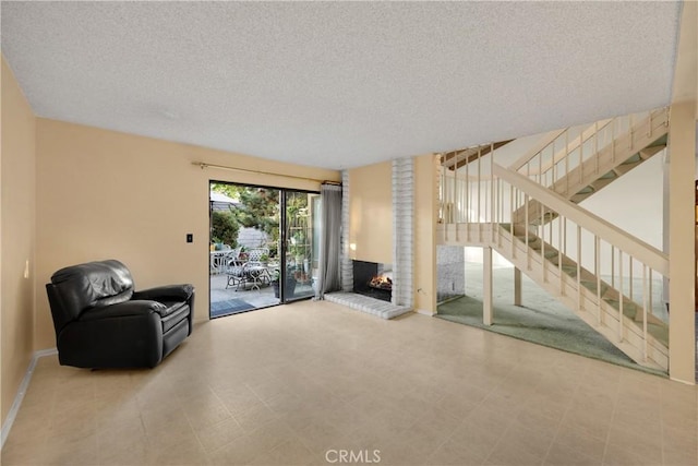 2622 N Tustin Ave Unit 147, Santa Ana, CA 92705 - unfurnished room featuring a textured ceiling, stairway, a fireplace, and tile patterned floors