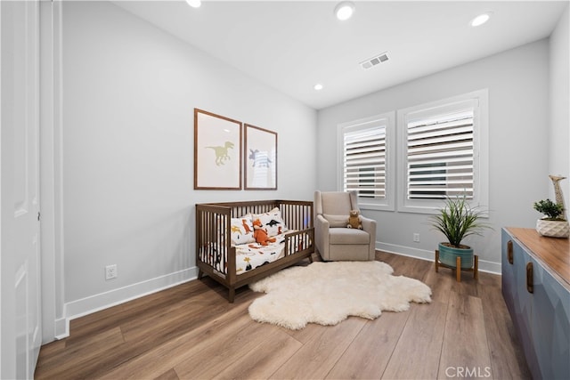 110 Mulberry, Lake Forest, CA 92630 - bedroom featuring wood finished floors, baseboards, recessed lighting, and a crib