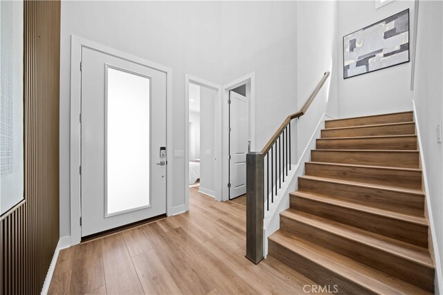 110 Mulberry, Lake Forest, CA 92630 - entryway featuring light wood-style flooring, stairway, and baseboards