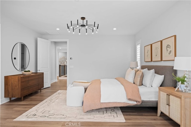 110 Mulberry, Lake Forest, CA 92630 - bedroom featuring a chandelier, recessed lighting, wood finished floors, and baseboards