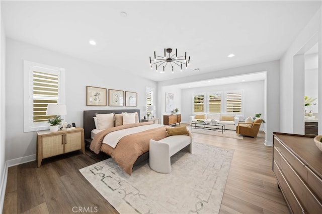 110 Mulberry, Lake Forest, CA 92630 - bedroom with a chandelier, wood finished floors, recessed lighting, and baseboards