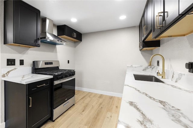 1000 Central Ave Unit 39, Riverside, CA 92507 - kitchen with stainless steel gas stove, wall chimney exhaust hood, a sink, dark cabinetry, and recessed lighting