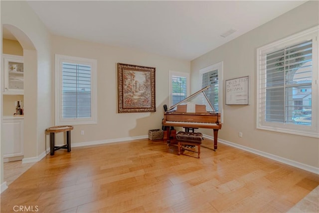 2551 Holly St, Fullerton, CA 92835 - living area with light wood finished floors, arched walkways, and baseboards