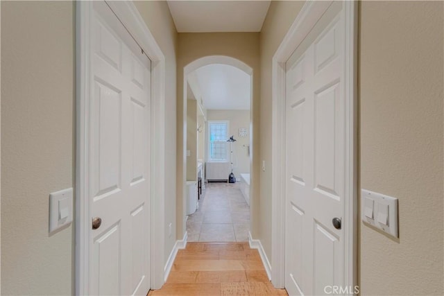 2551 Holly St, Fullerton, CA 92835 - corridor with arched walkways, light wood-style floors, and baseboards