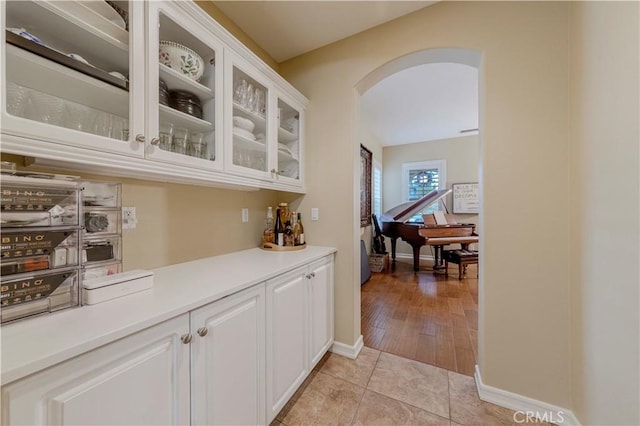 2551 Holly St, Fullerton, CA 92835 - bar area with arched walkways, light tile patterned floors, and baseboards