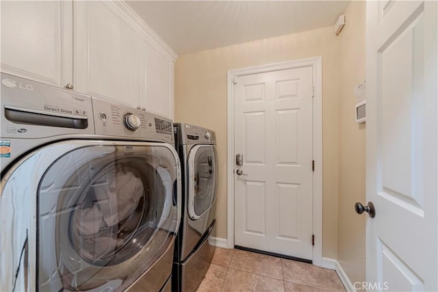 2551 Holly St, Fullerton, CA 92835 - laundry room featuring separate washer and dryer, cabinet space, light tile patterned floors, and baseboards