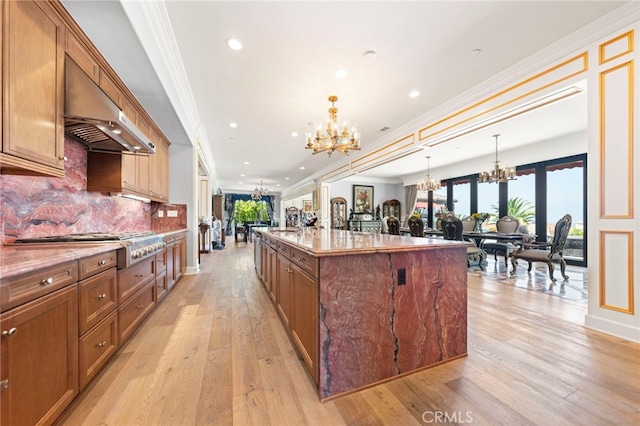 2825 Majestic St, West Covina, CA 91791 - kitchen featuring a chandelier, open floor plan, crown molding, ventilation hood, and a large island