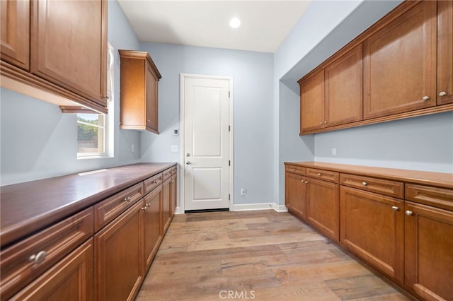 2825 Majestic St, West Covina, CA 91791 - kitchen with light wood-style floors, brown cabinetry, recessed lighting, and baseboards