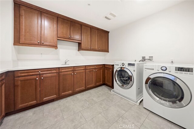 2825 Majestic St, West Covina, CA 91791 - washroom with washer and dryer, cabinet space, and light tile patterned floors
