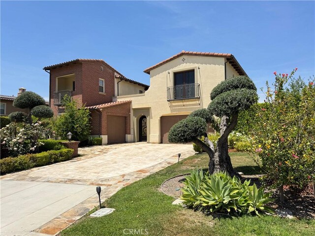 2825 Majestic St, West Covina, CA 91791 - mediterranean / spanish-style house featuring a tiled roof, a balcony, stucco siding, and driveway