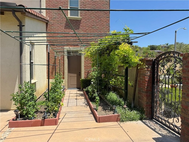 2825 Majestic St, West Covina, CA 91791 - view of exterior entry featuring brick siding and a gate
