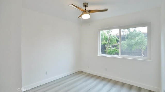 7909 Primrose Ln, Highland, CA 92346 - spare room featuring baseboards, wood finished floors, and ceiling fan