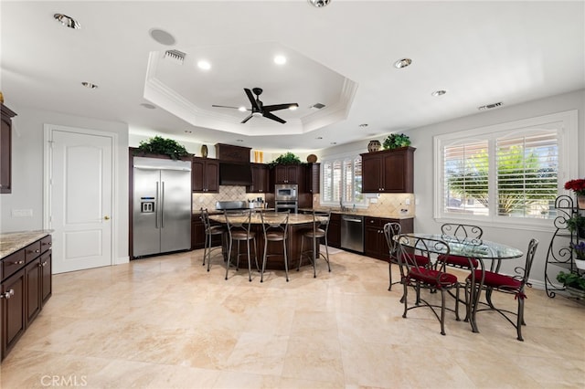 4009 Cerveza Cir, Corona, CA 92881 - kitchen with built in appliances, a kitchen bar, decorative backsplash, ceiling fan, and recessed lighting