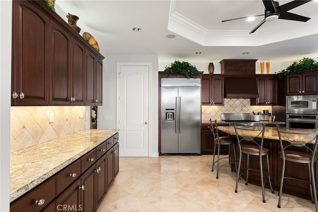 4009 Cerveza Cir, Corona, CA 92881 - kitchen with built in appliances, a kitchen breakfast bar, decorative backsplash, light stone countertops, and ornamental molding