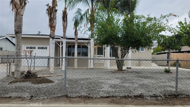 880 S State St, Hemet, CA 92543 - view of front of property featuring an attached garage, stucco siding, and roof mounted solar panels