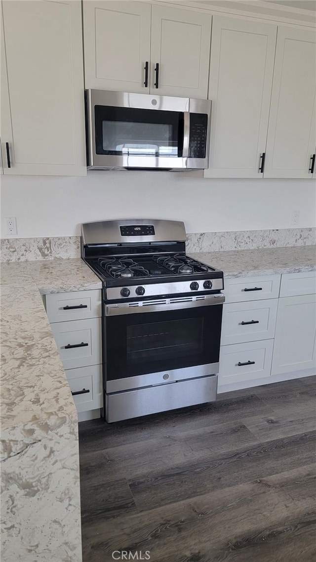 880 S State St, Hemet, CA 92543 - kitchen featuring stainless steel appliances, dark wood-type flooring, and white cabinetry