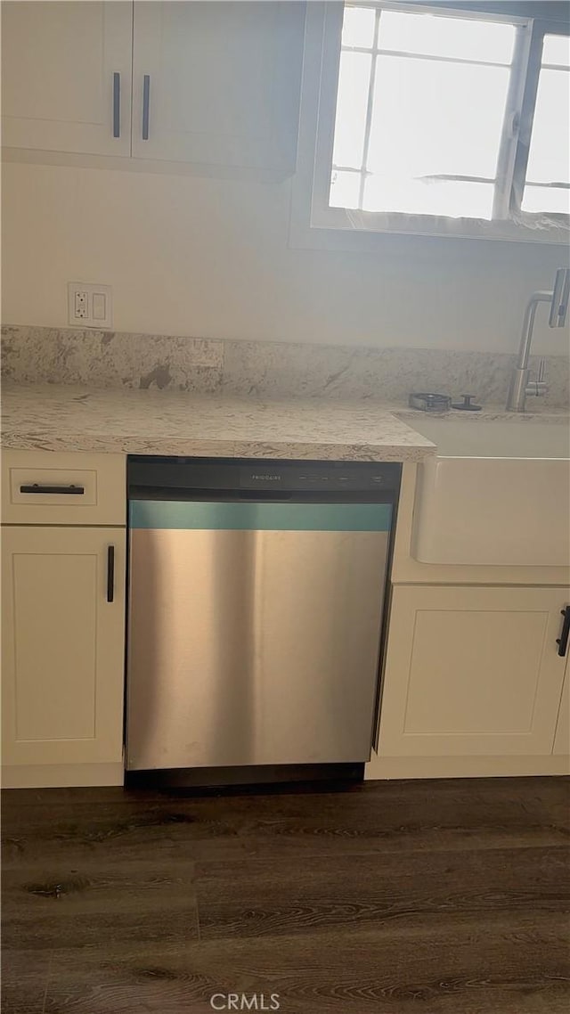 880 S State St, Hemet, CA 92543 - detailed view of stainless steel dishwasher, dark wood-style flooring, white cabinets, and light stone counters