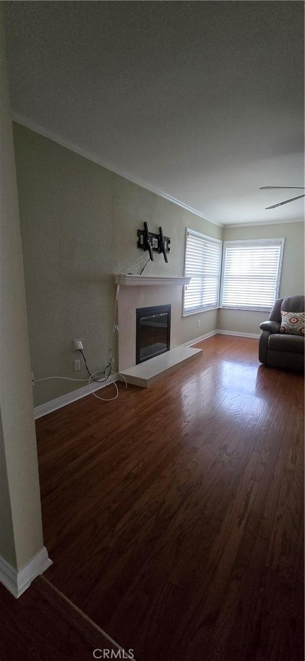 3349 Brookridge Rd, Duarte, CA 91010 - unfurnished living room featuring a glass covered fireplace, wood finished floors, and baseboards