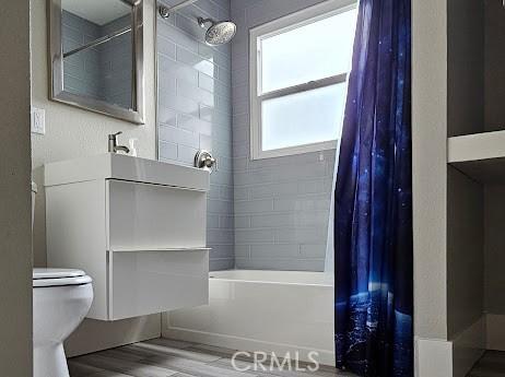 4107 37th St, San Diego, CA 92105 - bathroom with shower / bath combo with shower curtain, wood finished floors, toilet, and vanity