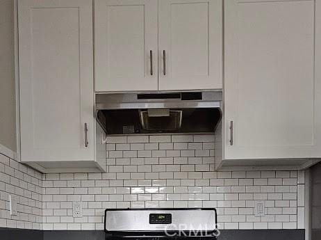4107 37th St, San Diego, CA 92105 - kitchen view of under cabinet range hood, white cabinetry, stove, and tasteful backsplash
