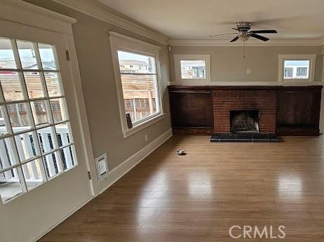 4107 37th St, San Diego, CA 92105 - unfurnished living room featuring ornamental molding, wood finished floors, ceiling fan, a fireplace, and baseboards