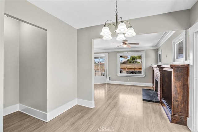 4107 37th St, San Diego, CA 92105 - unfurnished living room featuring a chandelier, light wood finished floors, ornamental molding, and a brick fireplace