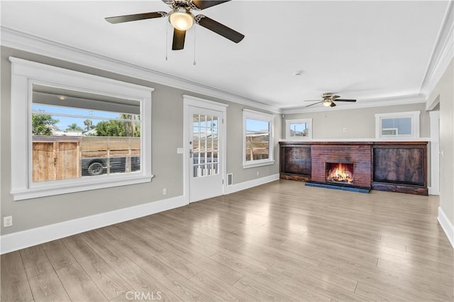 4107 37th St, San Diego, CA 92105 - unfurnished living room with a ceiling fan, crown molding, a fireplace, healthy amount of natural light, and wood finished floors