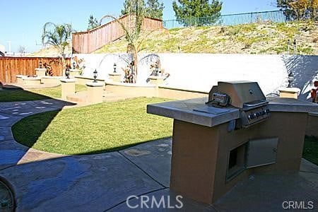 32489 Francisco Pl, Temecula, CA 92592 - view of patio featuring an outdoor kitchen and fence