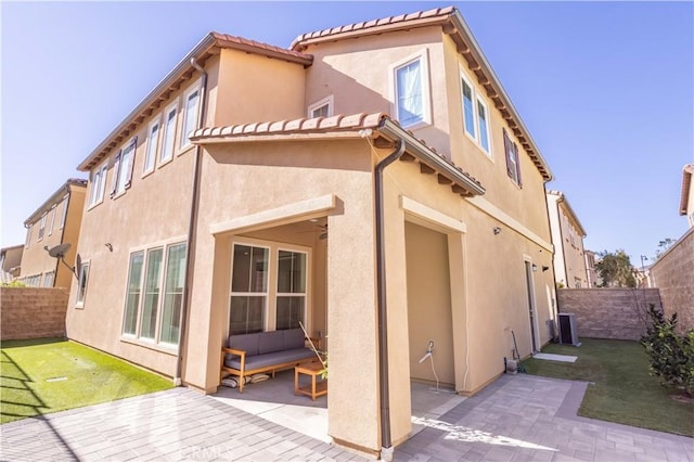 20621 Chestnut Cir, Porter Ranch, CA 91326 - rear view of house featuring a patio, a fenced backyard, stucco siding, and an outdoor living space
