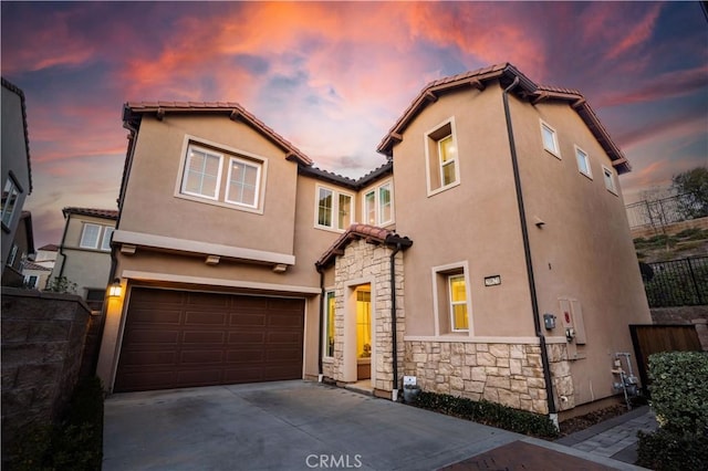20621 Chestnut Cir, Porter Ranch, CA 91326 - view of front of property featuring stone siding, a tiled roof, a garage, stucco siding, and concrete driveway