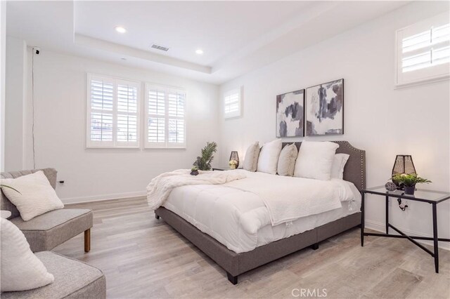 20621 Chestnut Cir, Porter Ranch, CA 91326 - bedroom with light wood-style flooring, baseboards, a raised ceiling, and recessed lighting