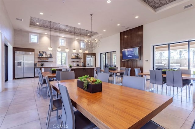 20621 Chestnut Cir, Porter Ranch, CA 91326 - dining space with a high ceiling, light tile patterned floors, recessed lighting, a raised ceiling, and a chandelier
