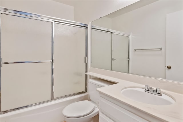 full bathroom with toilet, enclosed tub / shower combo, and vanity