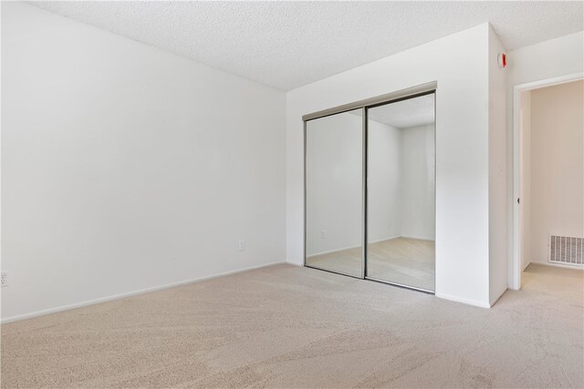 15555 Crestview Ln Unit 94, Granada Hills, CA 91344 - unfurnished bedroom with carpet floors, a closet, baseboards, and a textured ceiling